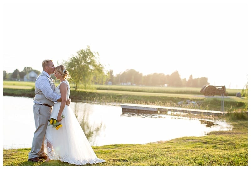 groom kissing brides forehead