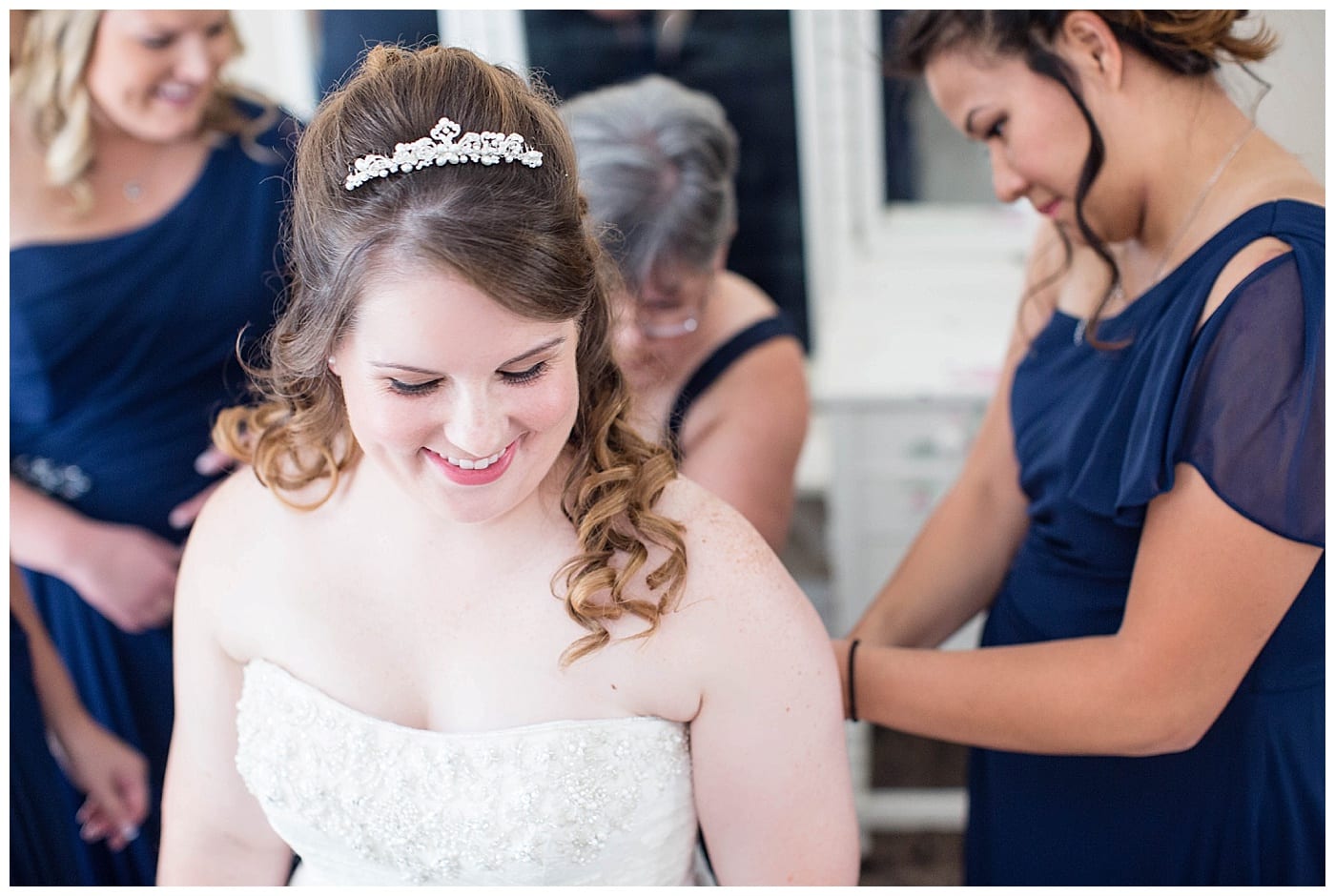 bride putting on dress